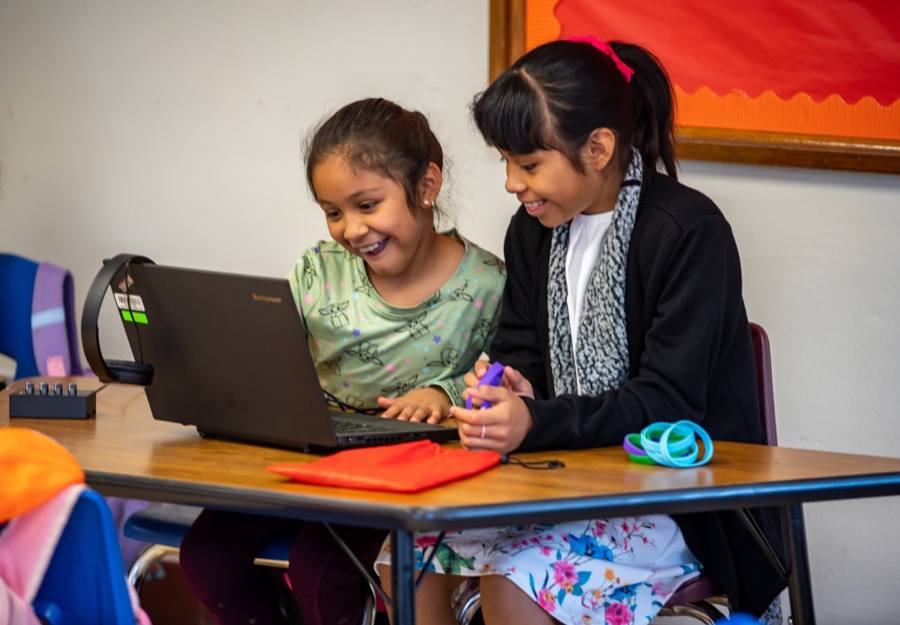 Two young students celebrate what they created together in an LTBB program.