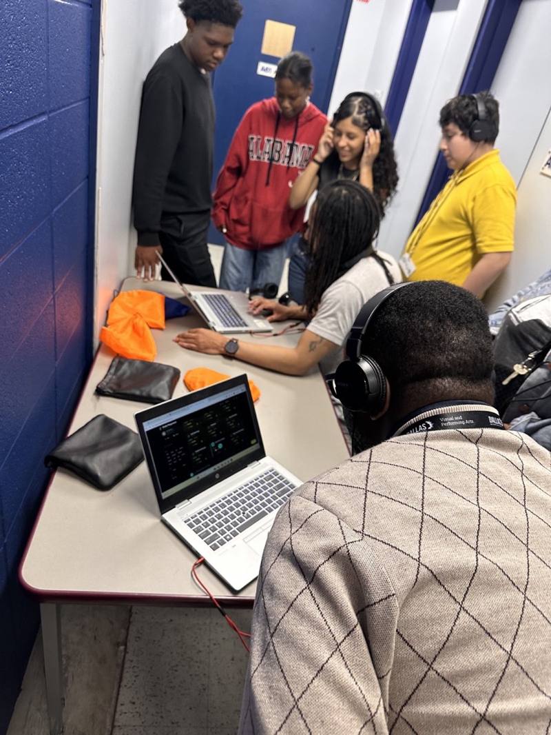 A student volunteer creates music on stage with LTBB.