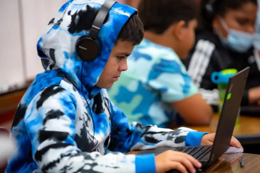 A student focuses on music production during an LTBB community program.