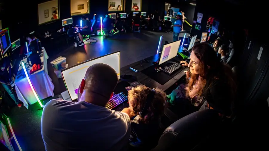 A mentor guides a young creator through music production tools.