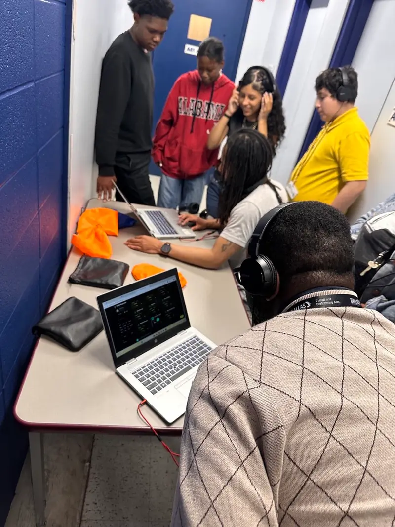 A student volunteer creates music on stage with LTBB.